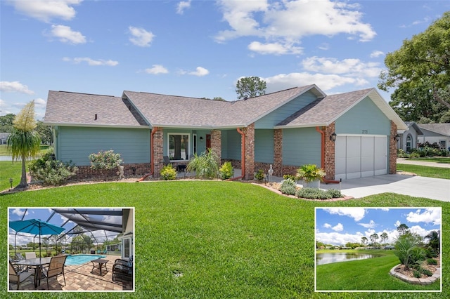 view of front of home featuring a garage, brick siding, a front yard, a water view, and driveway