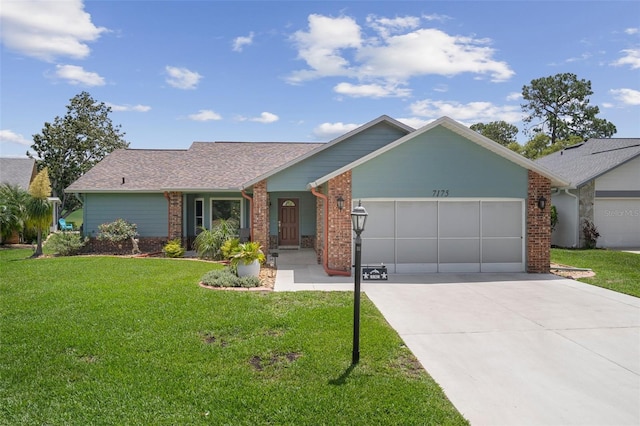 single story home with an attached garage, brick siding, driveway, and a front yard