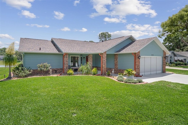 view of front facade with a garage, a front lawn, concrete driveway, and brick siding