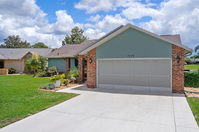 single story home featuring brick siding, a garage, driveway, a front yard, and a shingled roof
