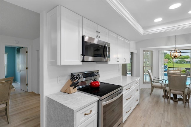 kitchen with stainless steel appliances, light wood-type flooring, white cabinets, a chandelier, and recessed lighting