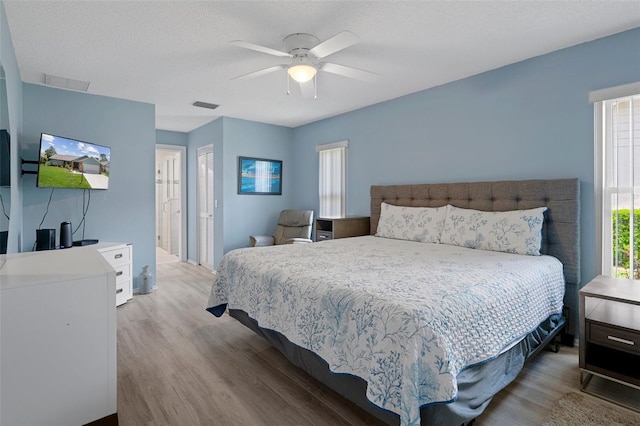 bedroom with light wood-style floors and ceiling fan