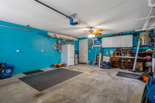 garage featuring freestanding refrigerator, a garage door opener, and a ceiling fan