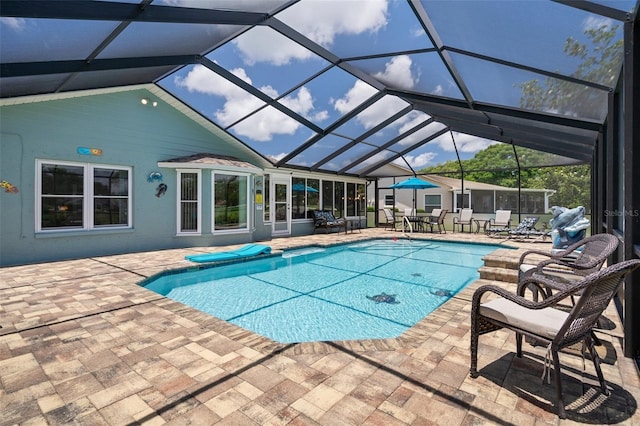outdoor pool with a patio area and glass enclosure