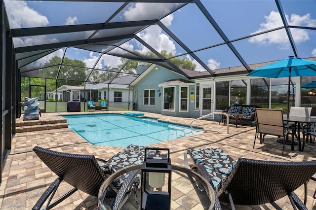 swimming pool featuring a patio and glass enclosure
