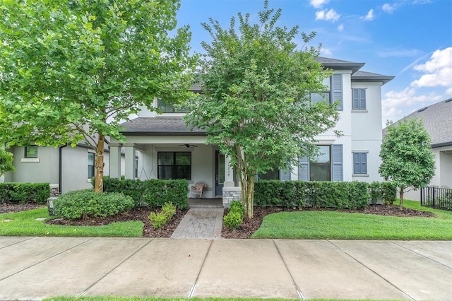 12854 Rangeland Blvd, Odessa, FL 33556 - view of property hidden behind natural elements featuring a porch, a ceiling fan, and stucco siding