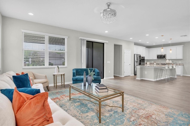 12854 Rangeland Blvd, Odessa, FL 33556 - living area featuring light wood finished floors, baseboards, and recessed lighting