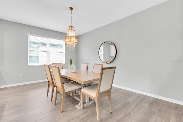 12854 Rangeland Blvd, Odessa, FL 33556 - dining area with a chandelier, light wood-type flooring, and baseboards