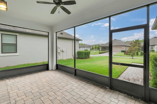 12854 Rangeland Blvd, Odessa, FL 33556 - unfurnished sunroom featuring ceiling fan, a residential view, and plenty of natural light