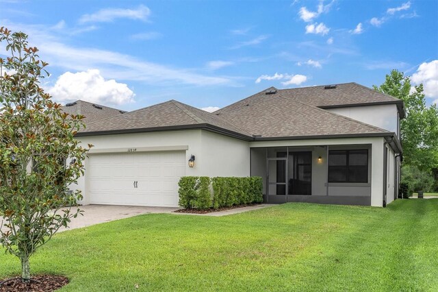 12854 Rangeland Blvd, Odessa, FL 33556 - back of property with a shingled roof, an attached garage, a yard, and stucco siding