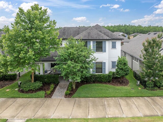 12854 Rangeland Blvd, Odessa, FL 33556 - view of front of property featuring stucco siding, roof with shingles, and a front yard