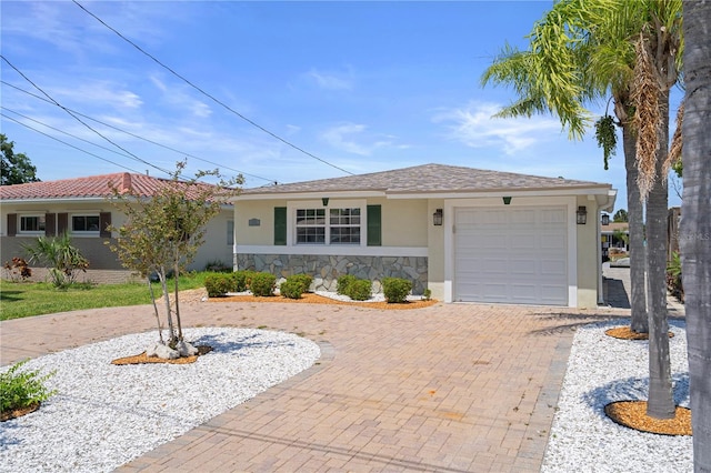5045 Pelican Dr, New Port Richey, FL 34652 - ranch-style house featuring decorative driveway, stucco siding, an attached garage, and stone siding