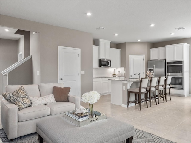 living room featuring recessed lighting and light tile patterned flooring
