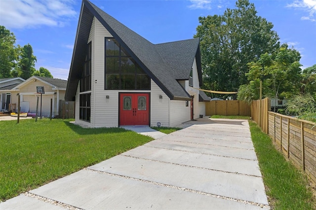 7422 New York Ave, Hudson, FL 34667 - a-frame home with a shingled roof and concrete driveway