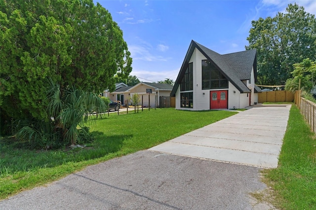 7422 New York Ave, Hudson, FL 34667 - a-frame style home with asphalt driveway and roof with shingles