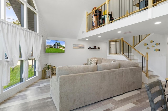 7422 New York Ave, Hudson, FL 34667 - living room with high vaulted ceiling, stairway, wood finished floors, and recessed lighting