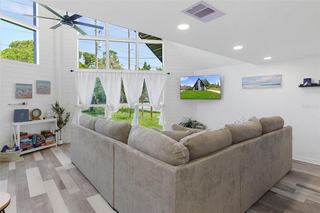 7422 New York Ave, Hudson, FL 34667 - living area with wood finished floors, a ceiling fan, recessed lighting, vaulted ceiling, and baseboards