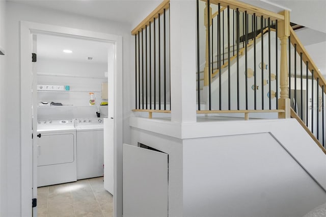 7422 New York Ave, Hudson, FL 34667 - hall with independent washer and dryer, stairway, recessed lighting, and light tile patterned floors
