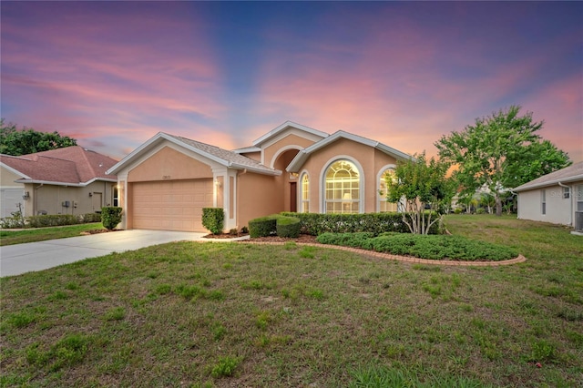 12071 Wexford Blvd, Spring Hill, FL 34609 - ranch-style house featuring a garage, concrete driveway, stucco siding, and a front yard