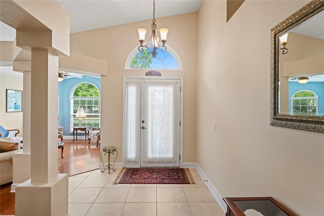 12071 Wexford Blvd, Spring Hill, FL 34609 - foyer with a ceiling fan, ornate columns, light tile patterned floors, baseboards, and a towering ceiling