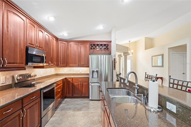 12071 Wexford Blvd, Spring Hill, FL 34609 - kitchen featuring stainless steel appliances, vaulted ceiling, a sink, dark stone counters, and backsplash
