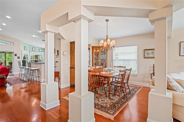 12071 Wexford Blvd, Spring Hill, FL 34609 - dining space featuring ornate columns, wood finished floors, recessed lighting, a chandelier, and baseboards