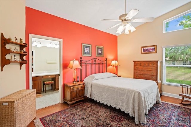 12071 Wexford Blvd, Spring Hill, FL 34609 - bedroom featuring wood finished floors, connected bathroom, a ceiling fan, and lofted ceiling