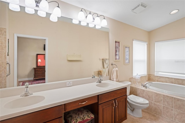 12071 Wexford Blvd, Spring Hill, FL 34609 - full bath featuring a garden tub, tile patterned floors, double vanity, toilet, and tiled shower