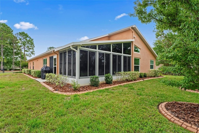 12071 Wexford Blvd, Spring Hill, FL 34609 - rear view of property with stucco siding, a sunroom, and a yard