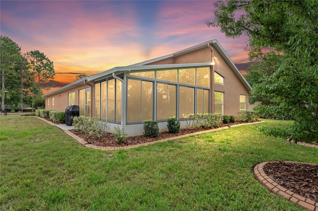 12071 Wexford Blvd, Spring Hill, FL 34609 - view of home's exterior featuring a sunroom and a yard