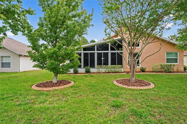 12071 Wexford Blvd, Spring Hill, FL 34609 - rear view of property with a lawn, a sunroom, and stucco siding