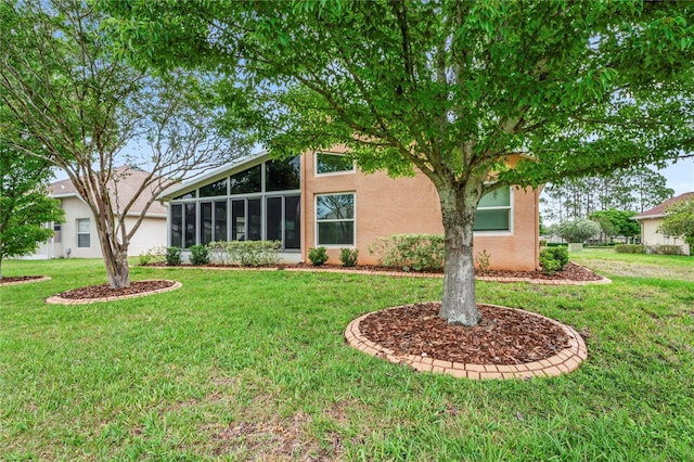 12071 Wexford Blvd, Spring Hill, FL 34609 - view of front of home featuring stucco siding, a front lawn, and a sunroom