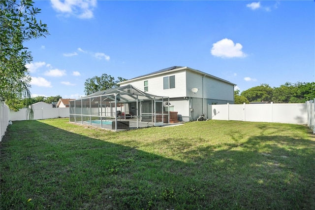 rear view of house with a lanai and a patio area