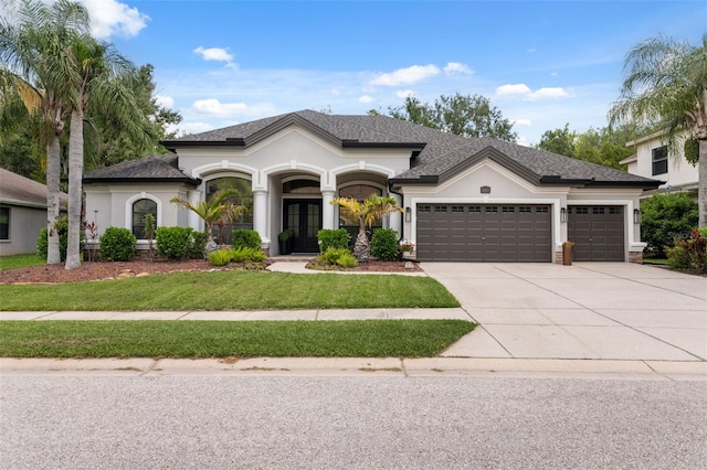 15413 Azra Dr, Odessa, FL 33556 - view of front facade featuring a garage, driveway, french doors, a front yard, and stucco siding