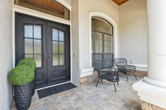 15413 Azra Dr, Odessa, FL 33556 - property entrance featuring french doors, stucco siding, and covered porch