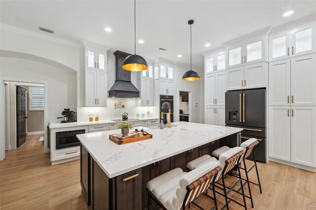 15413 Azra Dr, Odessa, FL 33556 - kitchen with black appliances, custom exhaust hood, crown molding, white cabinets, and backsplash