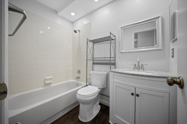 bathroom featuring toilet, wood finished floors, bathing tub / shower combination, vanity, and recessed lighting
