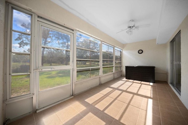unfurnished sunroom with ceiling fan