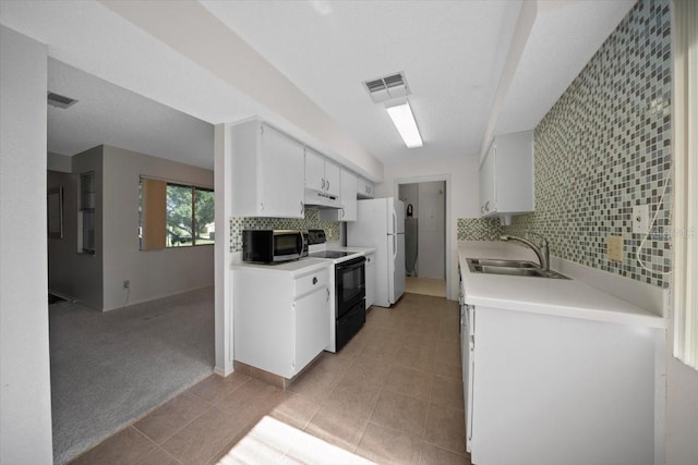 kitchen with range with electric cooktop, a sink, under cabinet range hood, stainless steel microwave, and light countertops
