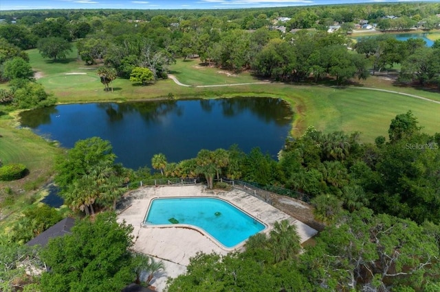 aerial view of property and surrounding area with a nearby body of water, a pool area, and a local golf course