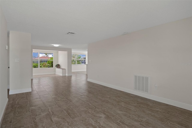 4937 Dory Dr, New Port Richey, FL 34652 - empty room featuring baseboards and a textured ceiling