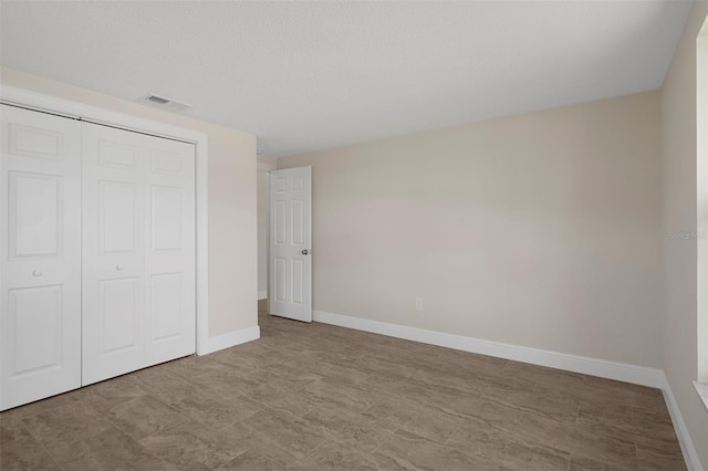 4937 Dory Dr, New Port Richey, FL 34652 - unfurnished bedroom featuring baseboards and a closet