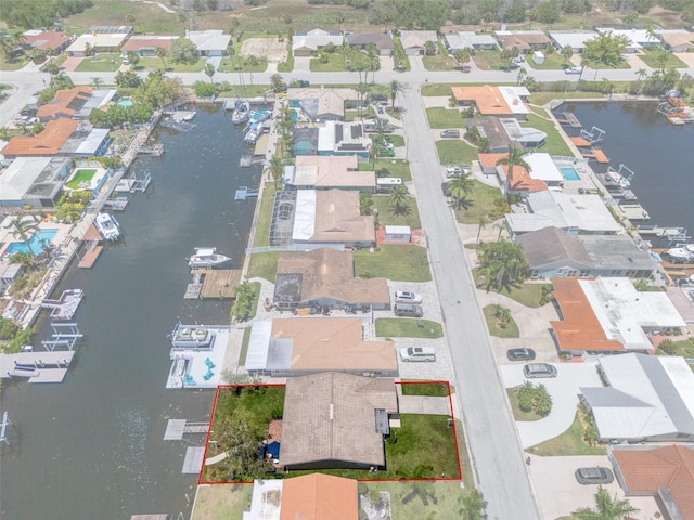 4937 Dory Dr, New Port Richey, FL 34652 - aerial view of residential area with property parcel outlined and a large body of water