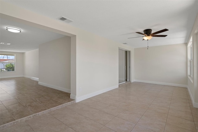 4937 Dory Dr, New Port Richey, FL 34652 - empty room featuring light tile patterned floors, ceiling fan, and baseboards