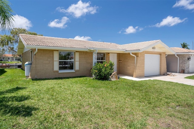 4937 Dory Dr, New Port Richey, FL 34652 - single story home with a tiled roof, stone siding, a garage, and driveway