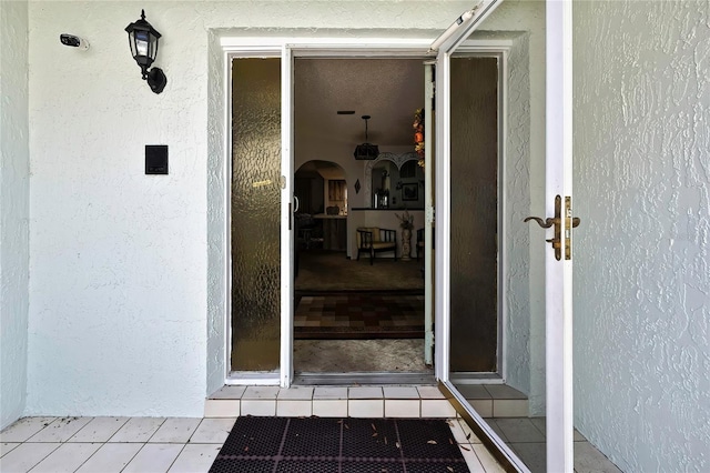 doorway to property with stucco siding