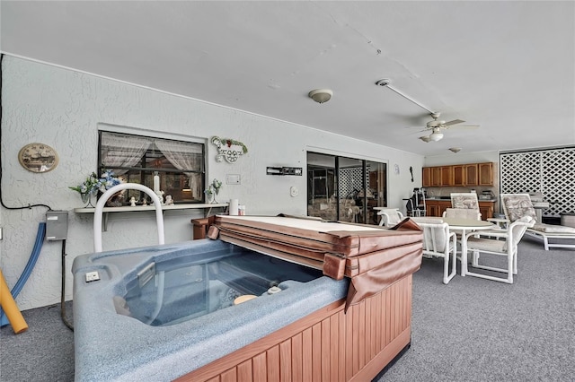 view of patio with a ceiling fan and a hot tub