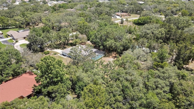 view of property location with a heavily wooded area