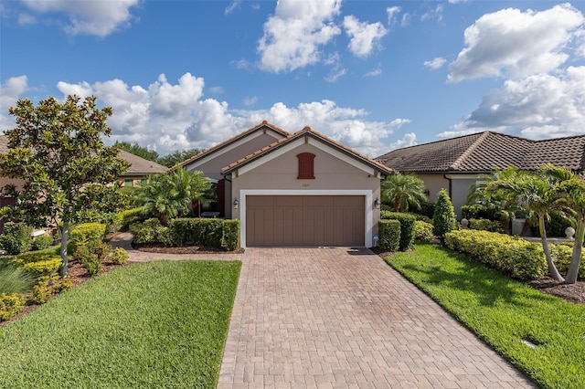 11611 Callisia Dr, Odessa, FL 33556 - view of front of home with decorative driveway, a garage, stucco siding, a front yard, and a tiled roof