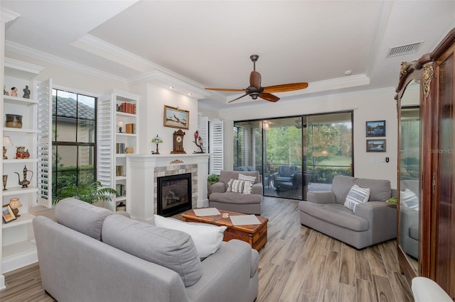 11611 Callisia Dr, Odessa, FL 33556 - living area featuring a raised ceiling, a ceiling fan, healthy amount of natural light, and ornamental molding
